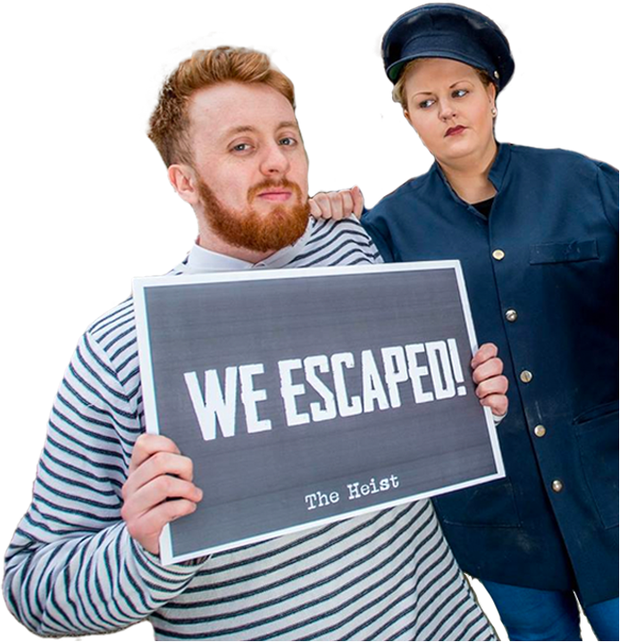 Guard holding prisoner who has a sign saying 'We escaped!'