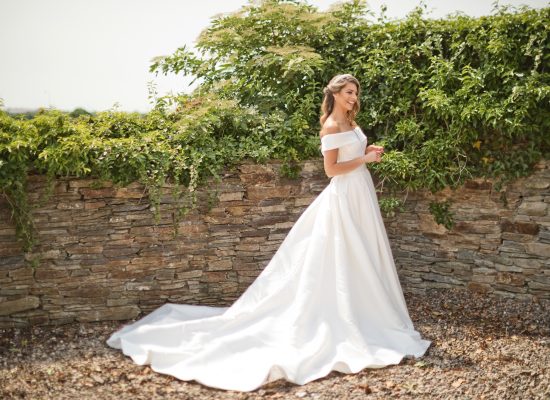 6S2A2487 Patrick bride standing outside in front of bushes