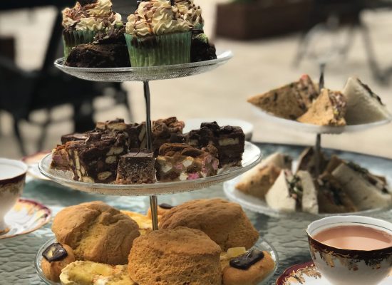 888E5863-270F-466A-A9F7-61AB21DBEFCE image of afternoon tea setup with three tiers of scones and buns