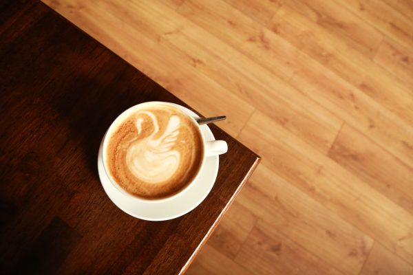 overhead shot of coffee with latte art of swan