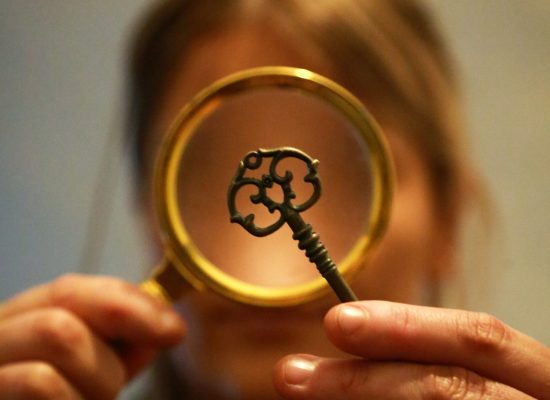 LIFFORD COURTHOUSE-45 Patrick woman looking at key through magnifying glass