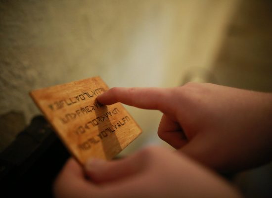 LIFFORD COURTHOUSE-5 Patrick reading rune letters on a plank of wood