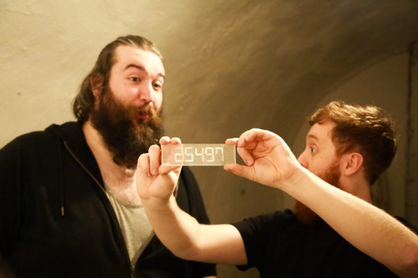 LIFFORD COURTHOUSE-55 Patrick man holding up clear plaque with numbers on it