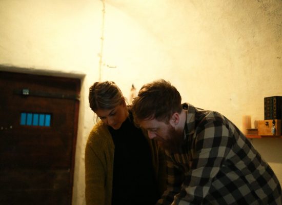 LIFFORD COURTHOUSE-8 Patrick man hunched over with woman looking at page on a small table