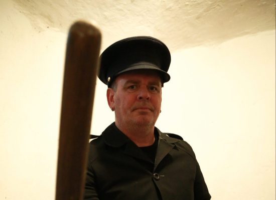 LIFFORD COURTHOUSE-83 Patrick prison guard with batton leaning towards camera